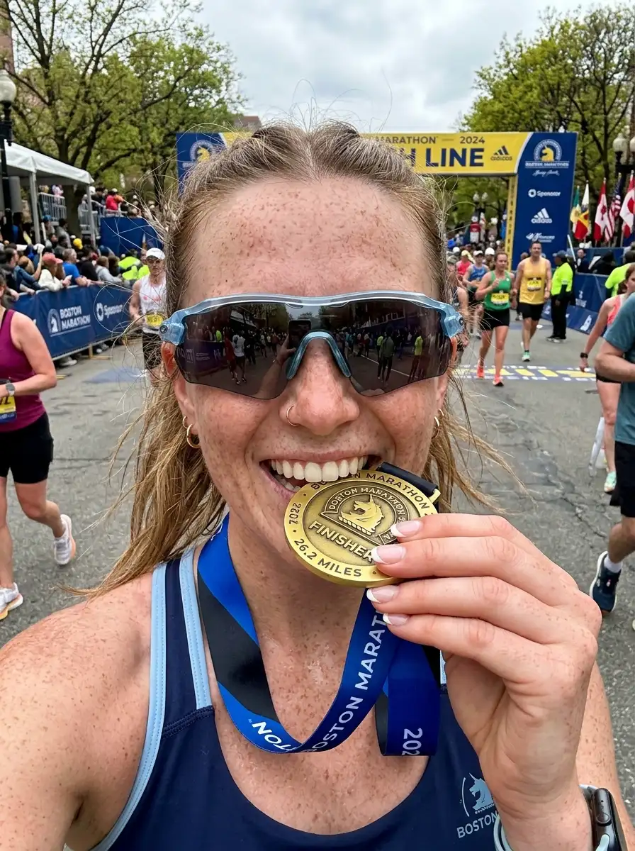 Woman_biting_medal_at_finish_202607130035